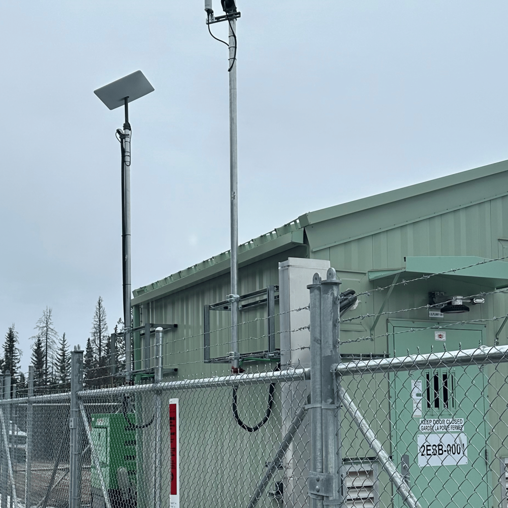 A Starlink Satellite Internet deployment installed near a utility shed in the Rocky Mountains of Alberta.